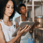 Small business owner reviewing budgets and cash flow with clarity and intention